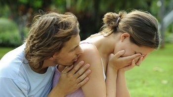 A man comforts a woman who has lost her pet.